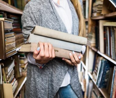 crop-woman-with-pile-books_23-2147848278 (1)
